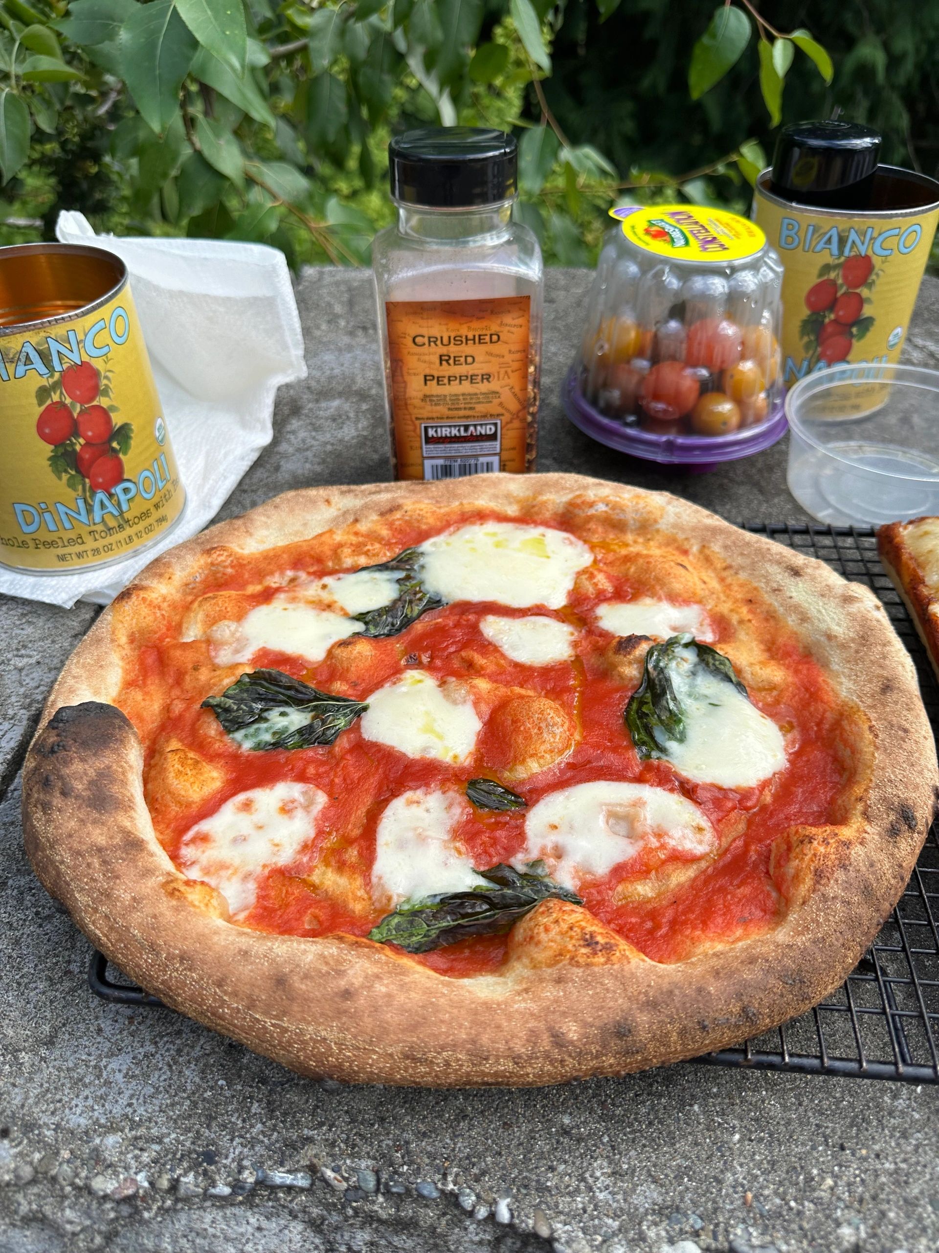 A hand-stretched Margherita pizza topped with fior di latte and torn basil.